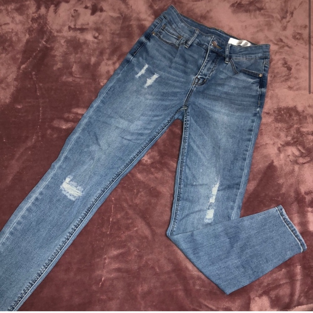 Distressed light blue high rise jeans